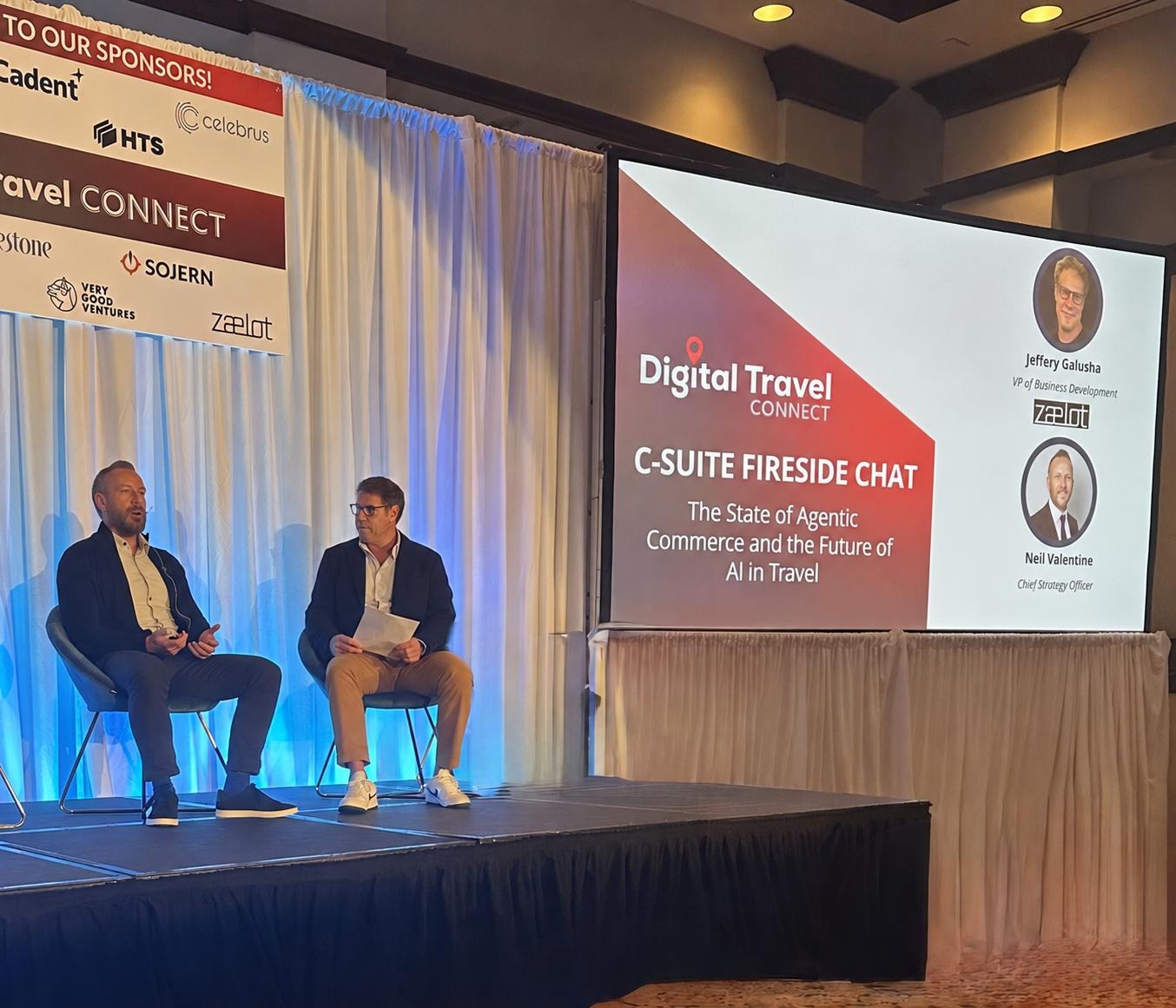 Neil Valentine on stage at a Digital Travel Connect fireside chat on agentic commerce